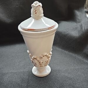 Elegant White Ceramic Lidded Urn with Floral Relief